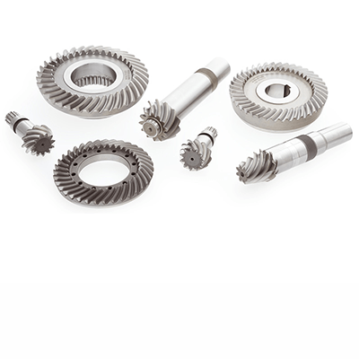 Several precision-machined metal bevel gears of various sizes, arranged to illustrate gear components.